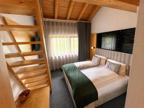 a bedroom with a bunk bed and a ladder at Hotel Pizzeria Selva in Zernez