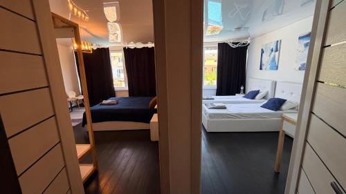 a small room with two beds and a mirror at Вілла с басейном in Zatoka