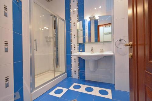 a bathroom with a sink and a shower and a toilet at Tumanyan Guesthouses in Yerevan