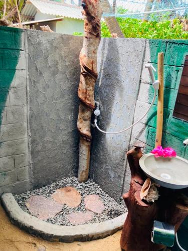 a bathroom with a sink next to a wall at Rooms at Maduka Restaurant in Ilandaiyadi