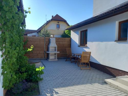 a patio with chairs and a table and a fence at Apartman Hanzky in Veselí nad Lužnicí