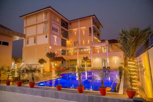 a hotel with a swimming pool in front of a building at Gautam Hotel Dhanusha in Lālbhitti