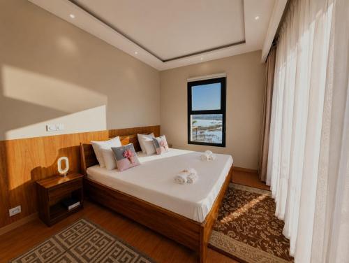 a bedroom with a large bed with a window at Riva guest house in Antananarivo