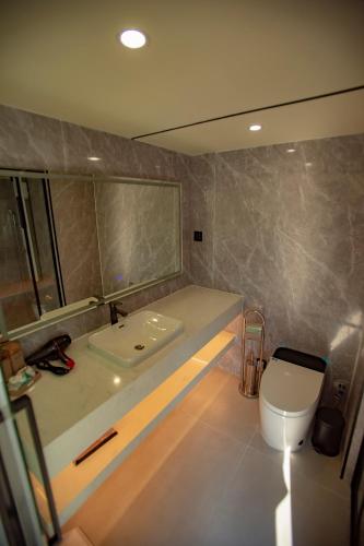 a bathroom with a sink and a toilet at Mars Oasis Capsule in Charnali