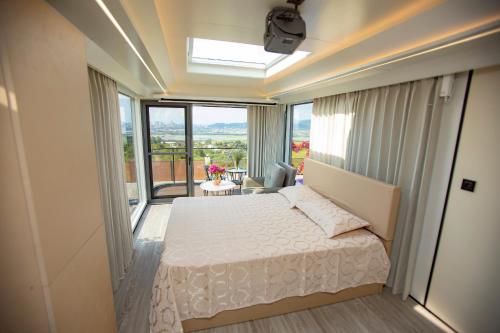 a bedroom with a bed and a large window at Mars Oasis Capsule in Charnali