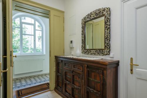 a bathroom with a sink and a mirror on the wall at Atrium Apartments in Brno