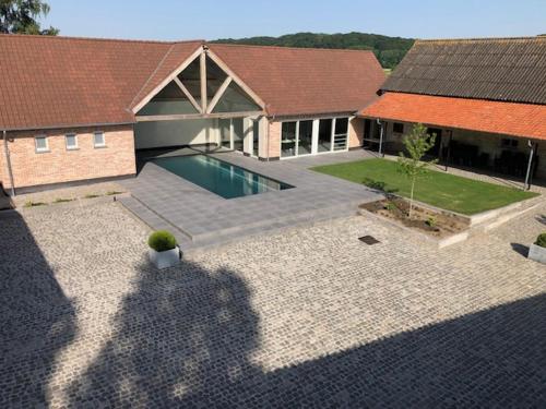 a house with a swimming pool in the backyard at Hof Ten Beemd in Oudenaarde