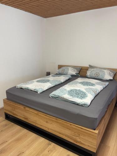 a bed with two pillows on top of it at Garten Oase Weisweil in Weisweil