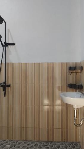 a bathroom with a white sink and a shower at USTIN Villas Lombok in Bumbang