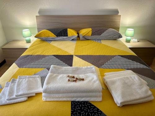 a bed with white towels and pillows on it at La Farfalla B&B - Mark&Rosy in Malonno