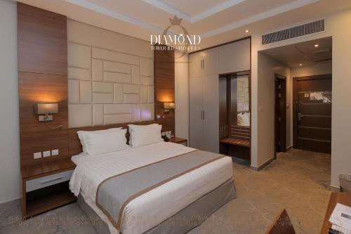 a bedroom with a large bed in a room at Diamond Tower Hotel in Jeddah