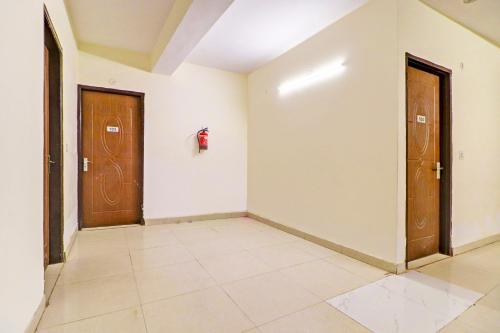 a hallway with two doors and a tile floor at Hotel O Honey Inn in New Delhi