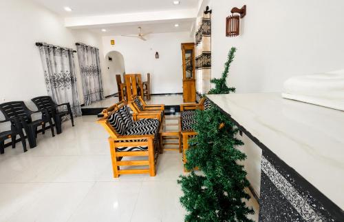 a lobby with chairs and a counter with christmas trees at Blue Waves Ocean Mirissa in Mirissa