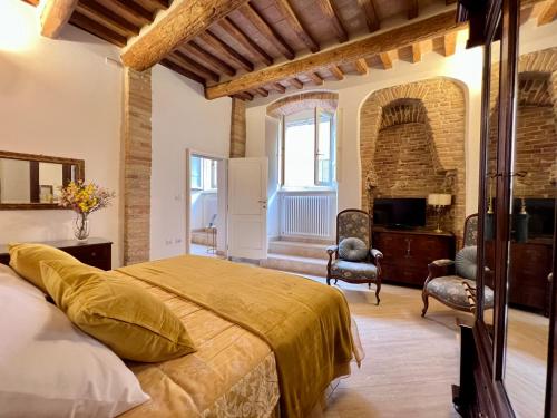 a bedroom with a large bed and a fireplace at Pinturicchio Luxury Suite in Perugia