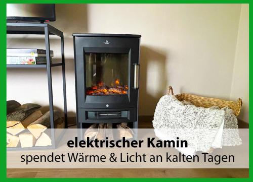 a fireplace in a living room with the words safeguard wane and light an kitchen at MARKs Ferienwohnung in Bad Sachsa - waldnah, hundefreundlich, ruhig! Ideal für Paare mit Hund in Bad Sachsa