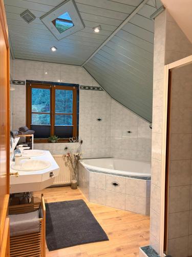 a bathroom with a tub and a sink at Ferienhaus Sophia & Ilse in Murau