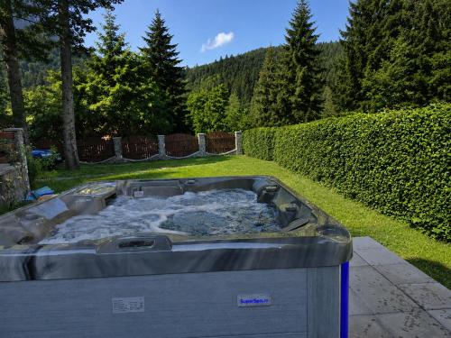 a hot tub in the backyard of a yard at RED HOUSE Sinaia in Sinaia