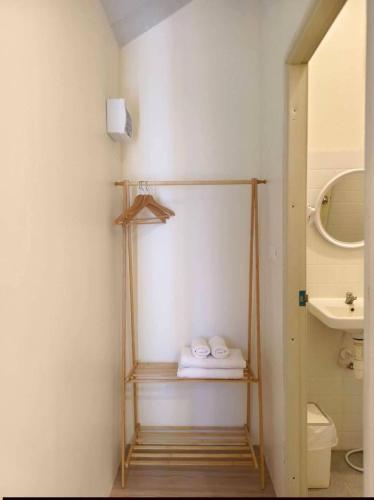 a bathroom with a towel rack and a sink at บ้านตัวเล็กศาลายา in Sathani Wat Suwan