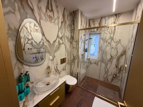 a bathroom with a shower and a sink and a mirror at Hotel BOUTIQUE in Tisno
