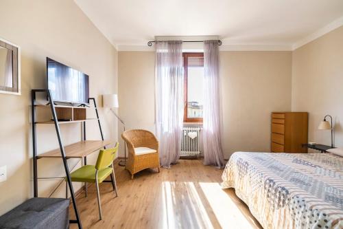 a bedroom with a bed and a desk and a chair at Da Chiara in Pistoia