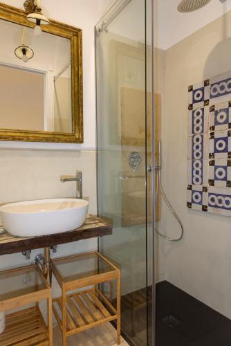 a bathroom with a sink and a glass shower at Circumpiso in Massa Lubrense