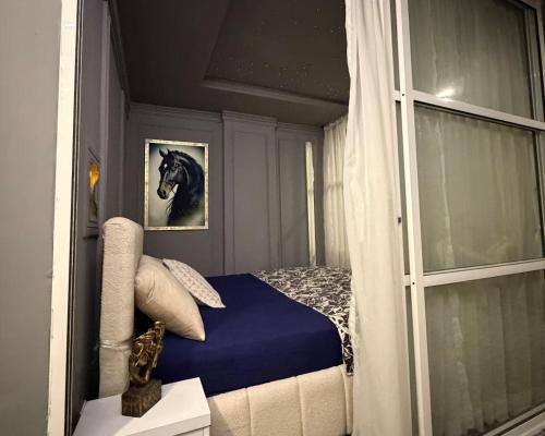 a bedroom with a bed with a picture of a horse at premium category 2 bedrooms apartment in Lahore