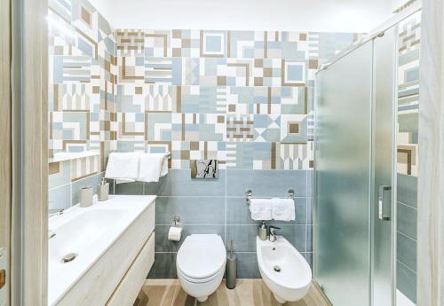 a bathroom with a toilet and a sink and a shower at Villetta Mami in Ischia