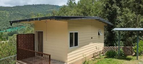 a small yellow building with a black roof at Fursat Exclusive Solitude in Rāmgarh