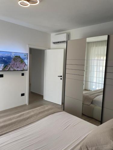 a bedroom with a bed and a flat screen tv at Villa Golden Star in Zaton
