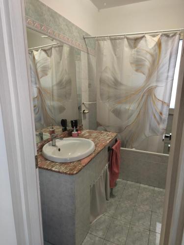 a bathroom with a sink and a bath tub at Cibali rooms in Catania