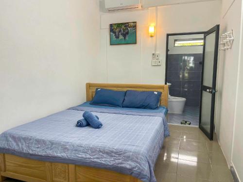 a bedroom with a bed with a blue stuffed animal on it at Phu Yen Beachfront Fishing Village Homestay in Tuy Hoa