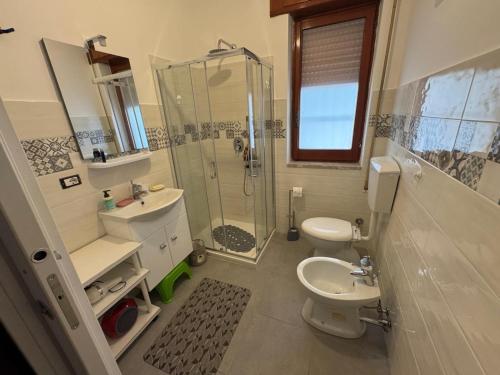 a bathroom with a shower and a toilet and a sink at Happy Rock in Formia