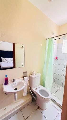 a bathroom with a toilet and a sink and a shower at 3 bedroom house buxton in Mombasa