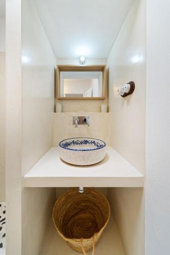 a bathroom with a sink and a mirror at Sardina Ocean Front Apartment in Gáldar