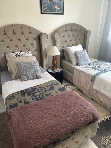 a bedroom with two beds and a headboard at Laila in Creil