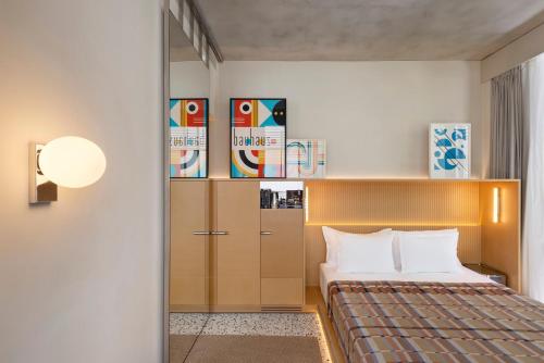 a hotel room with a bed and a closet at Dizengoff 99 by Isrotel Design in Tel Aviv