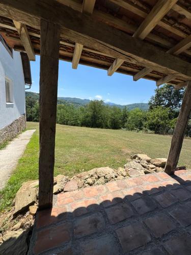 a view of a field from the porch of a house at Imanje Kovačević in Gornji Milanovac
