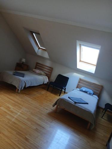 a room with two beds and a couch and a window at “Airīši” in Alūksne