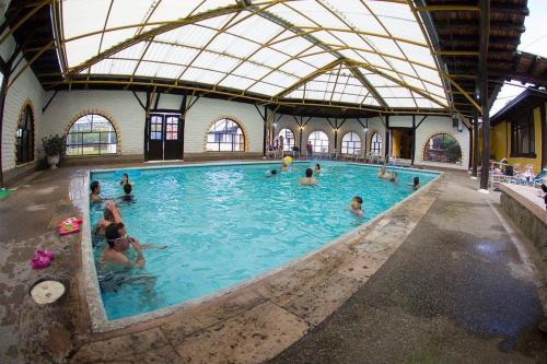 a group of people in a swimming pool at Hotel y Hosteria Natabuela in Natabuela