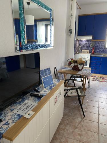 a kitchen with a table and a large mirror at Sofia's house in Possidi