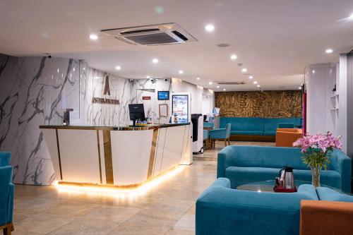 a lobby with a reception counter and blue furniture at A25 Premium Hotel - 12 Ngô Sỹ Liên in Hanoi