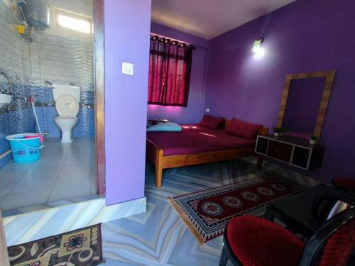 a purple room with a bed and a toilet at Lavender Guesthouse in Cherrapunji