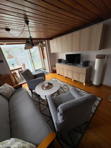 a living room with a couch and chairs and a table at Privat Medo in Děpoltovice