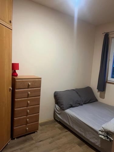 a bedroom with a bed and a dresser at Rzeczny azyl in Pomiechówek