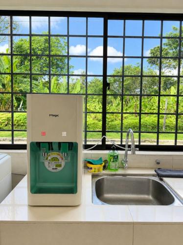 a machine sitting on a kitchen counter next to a sink at Kemaman AY Home in Cukai
