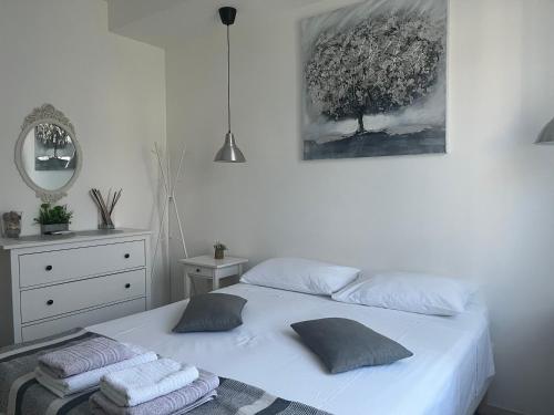 a bedroom with a white bed with towels on it at Julia affittacamere in Trieste