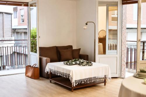 a living room with a couch and a table at Terraza esquina en el centro in Elche