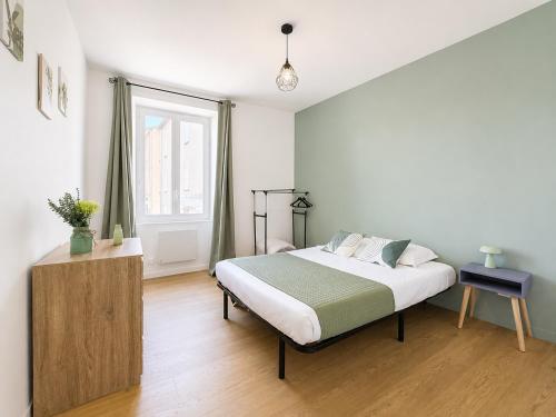 a bedroom with a large bed and a window at 8A - Le Nid in Saint-Rambert-dʼAlbon