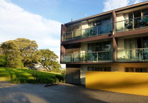 an apartment building with balconies and a yard at Park Ridge Retreat in Gerringong