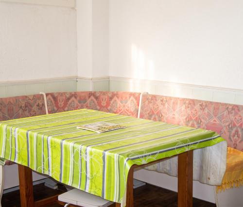 a table with a yellow and green table cloth on it at Studio confortable à Valras-Plage de 26 m² in Valras-Plage